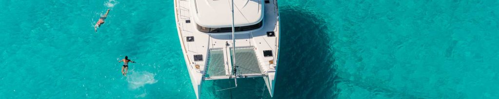Catamaran boat with a group of friends enjoying their chartered boat.